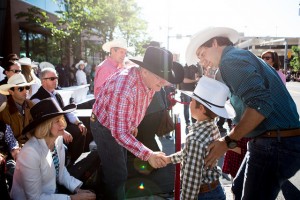 In a rare show of civility, Harper shakes Xavier Trudeau's hand, before turning to crowd and reminding them Trudeau is trying to push pot on their children.